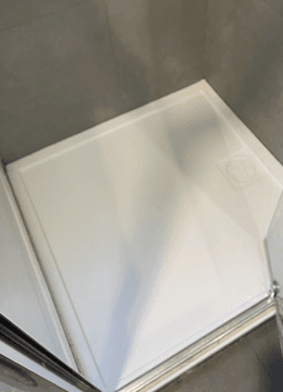 Shower resealed and coated so the crack is no longer visible