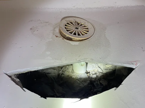 Damaged shower base with cracks