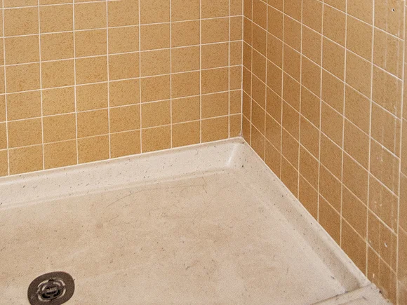 Damaged shower base with cracks