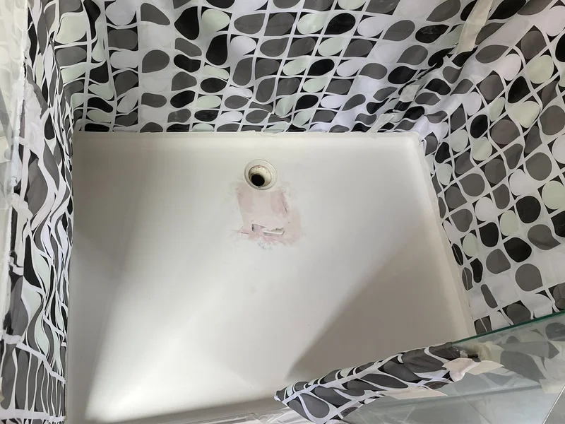 Damaged shower base with cracks