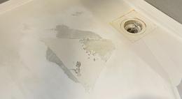 Shower base crack filled and sanded during repair